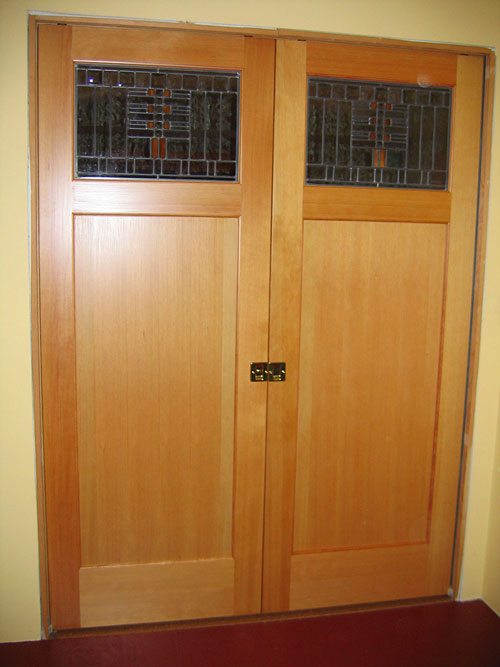 Double pocket door with custom stained glass panels
